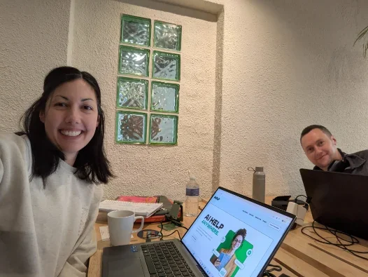 Working together around a table with laptops