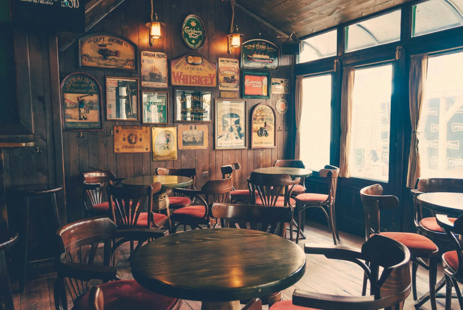 Tables and chairs inside a traditional wood-panelled pub